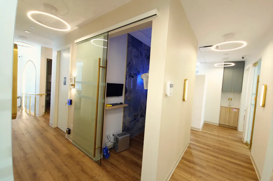 Corridor with halo lighting and private treatment rooms at Monaco Dentistry