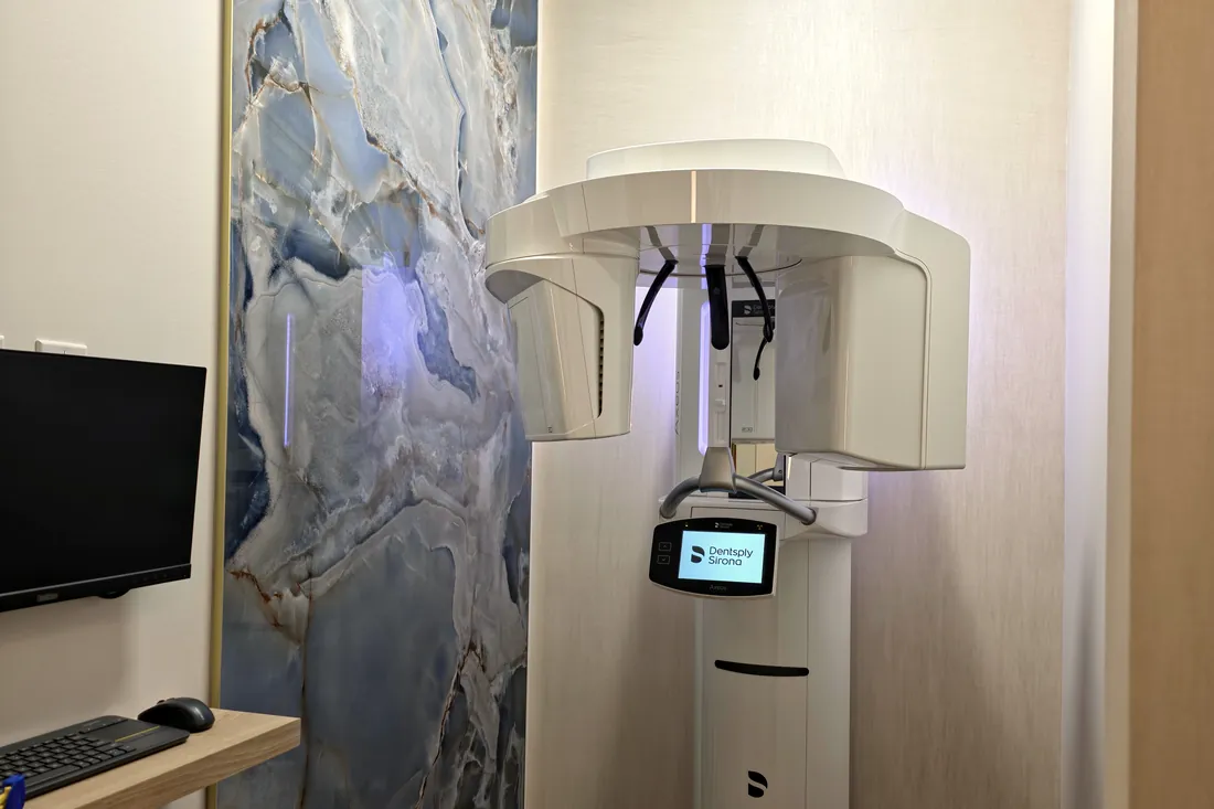 Dentsply Sirona CBCT 3D imaging unit lit in blue in its own room at Monaco Dentistry